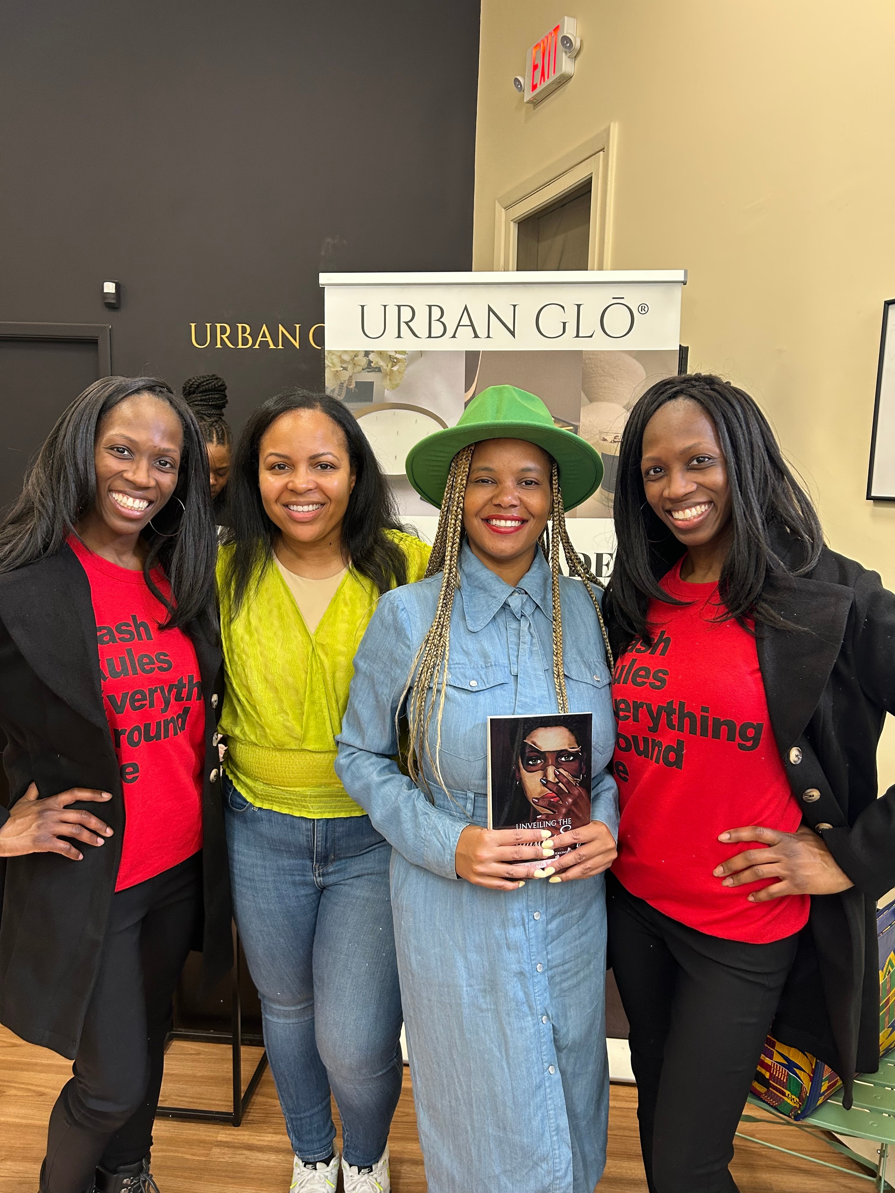 Women at a bookstore event holding the book
